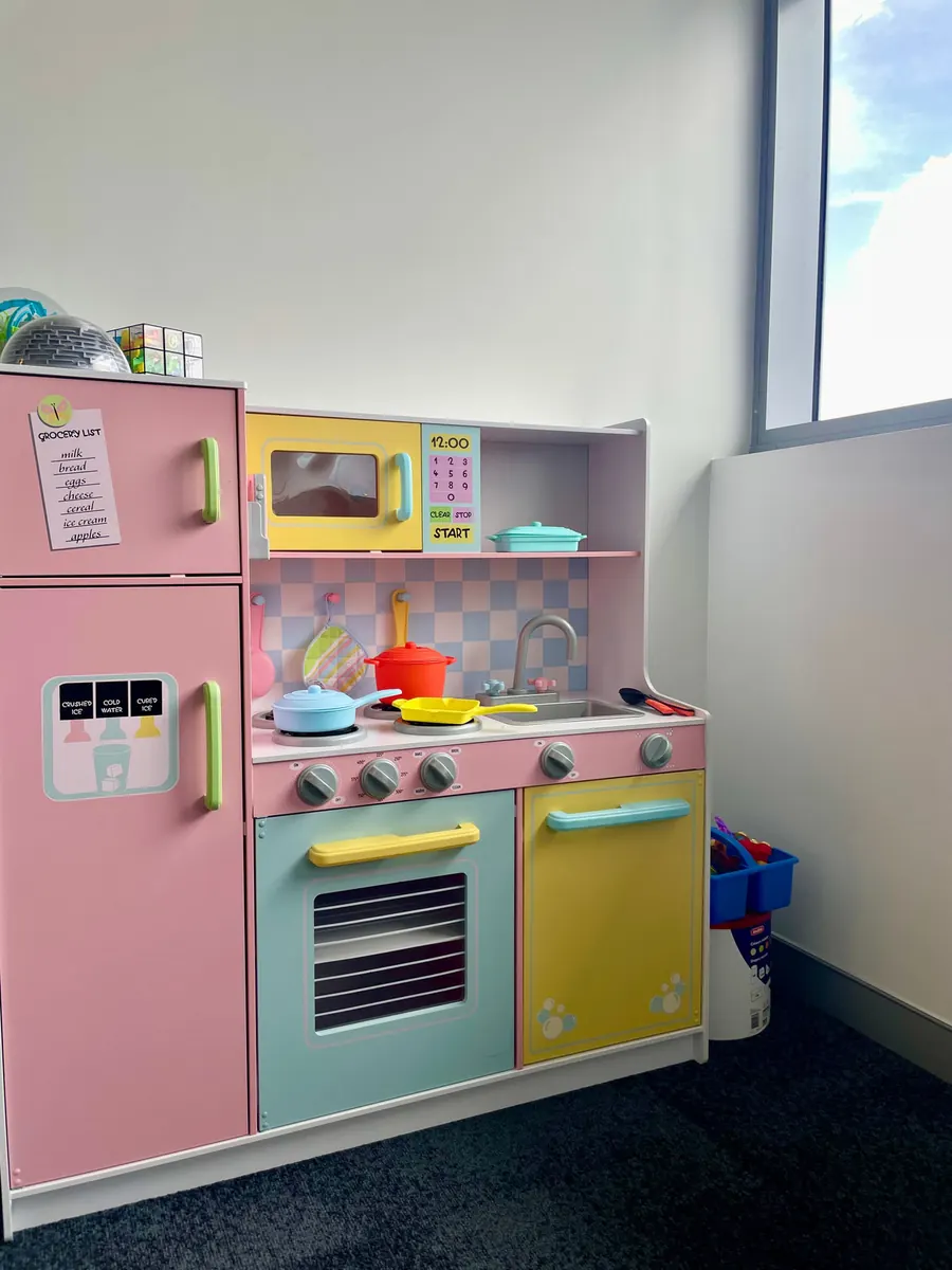 A play kitchen and toys in a Paeds Plus therapy space