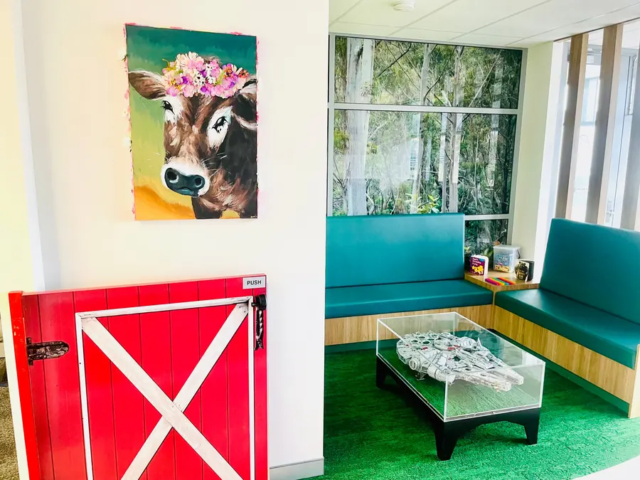 A quiet corner of the Paeds Plus waiting area with a bench seat